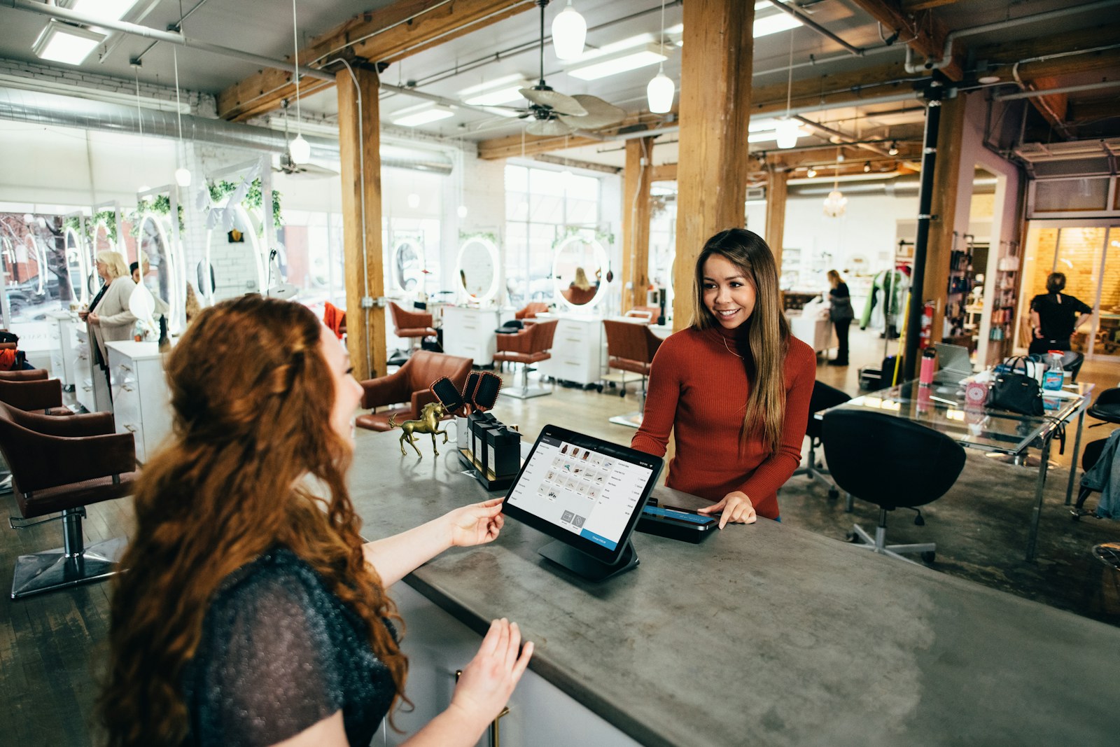 Customer paying at a modern checkout counter